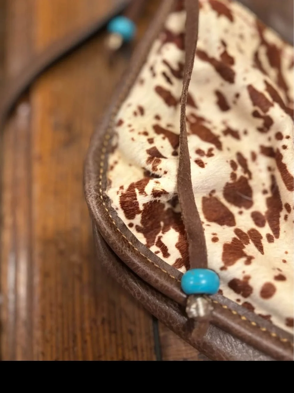 Brown Leather Crossbody Bag with Cowhide Accent and Patterned Strap